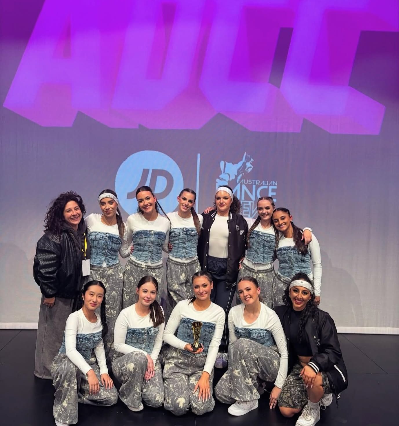 A Dance Effects competition troupe together with their trophy at a Melbourne dance championship